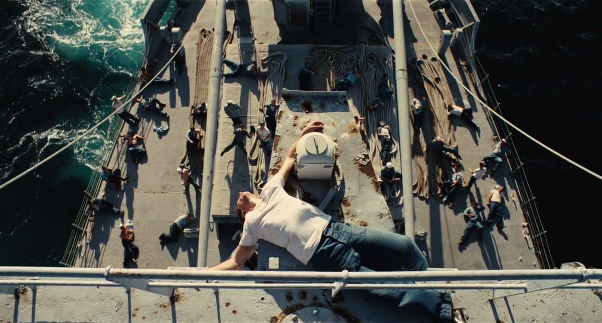 A man lies on the top of the hull of a ship